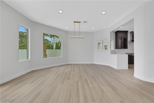 2589 Sun Reef Rd, Las Vegas, NV 89128 - unfurnished living room featuring light wood finished floors, recessed lighting, and a chandelier