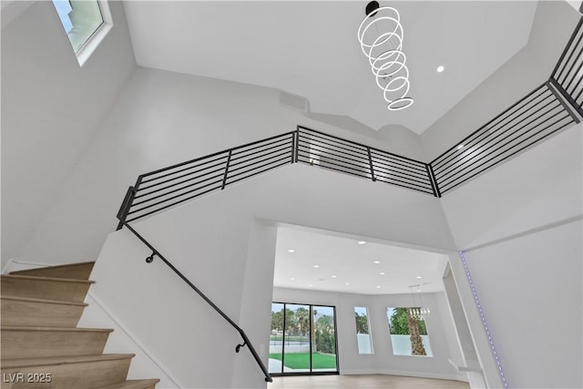 2589 Sun Reef Rd, Las Vegas, NV 89128 - staircase featuring a towering ceiling and recessed lighting