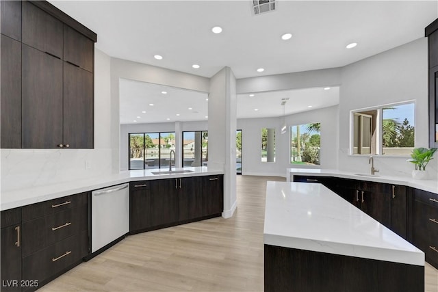 2589 Sun Reef Rd, Las Vegas, NV 89128 - kitchen featuring stainless steel dishwasher, light wood-type flooring, recessed lighting, backsplash, and modern cabinets