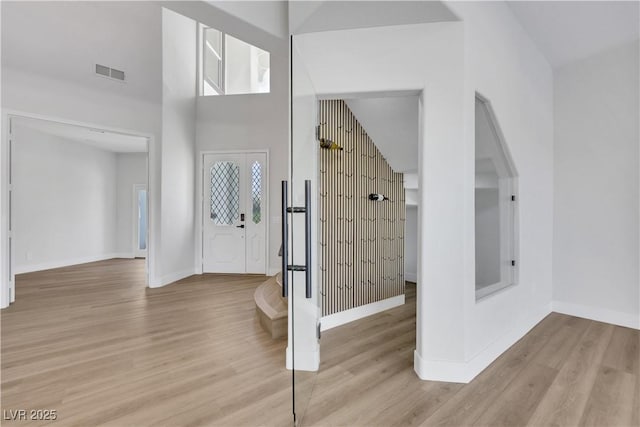 2589 Sun Reef Rd, Las Vegas, NV 89128 - foyer entrance featuring wood finished floors, a high ceiling, and healthy amount of natural light