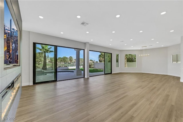 2589 Sun Reef Rd, Las Vegas, NV 89128 - unfurnished living room featuring light wood-style floors, recessed lighting, and a fireplace