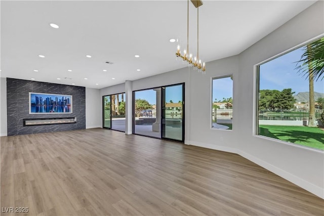 2589 Sun Reef Rd, Las Vegas, NV 89128 - unfurnished living room with wood finished floors, recessed lighting, and a high end fireplace