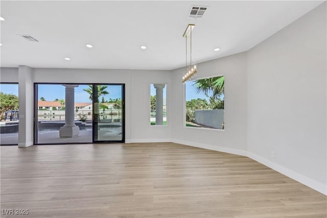 2589 Sun Reef Rd, Las Vegas, NV 89128 - spare room featuring decorative columns, light wood-type flooring, and recessed lighting