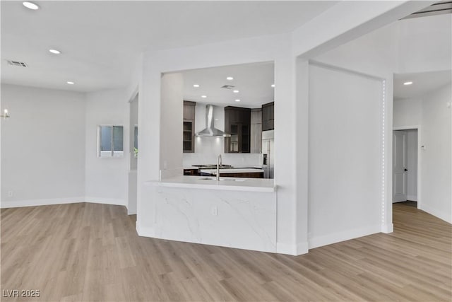 2589 Sun Reef Rd, Las Vegas, NV 89128 - kitchen featuring wall chimney exhaust hood, built in fridge, light wood finished floors, light countertops, and recessed lighting