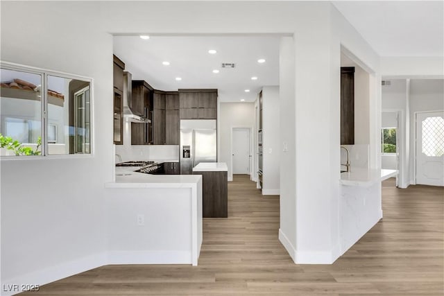 2589 Sun Reef Rd, Las Vegas, NV 89128 - kitchen featuring built in fridge, light countertops, dark brown cabinets, a peninsula, and recessed lighting
