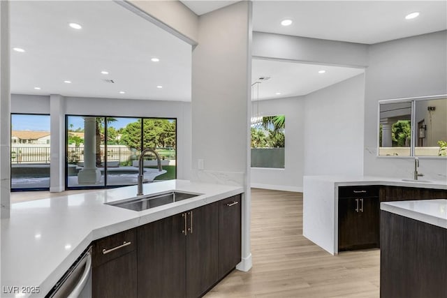 2589 Sun Reef Rd, Las Vegas, NV 89128 - kitchen featuring light wood-type flooring, dark brown cabinetry, recessed lighting, and stainless steel dishwasher