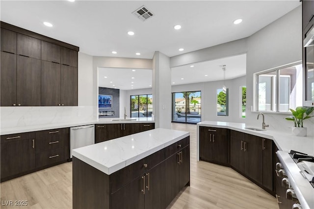 2589 Sun Reef Rd, Las Vegas, NV 89128 - kitchen featuring decorative backsplash, light wood-style floors, dishwasher, and recessed lighting