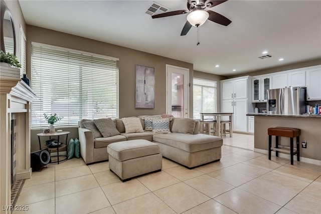living area featuring visible vents, light tile patterned flooring, ceiling fan, and recessed lighting
