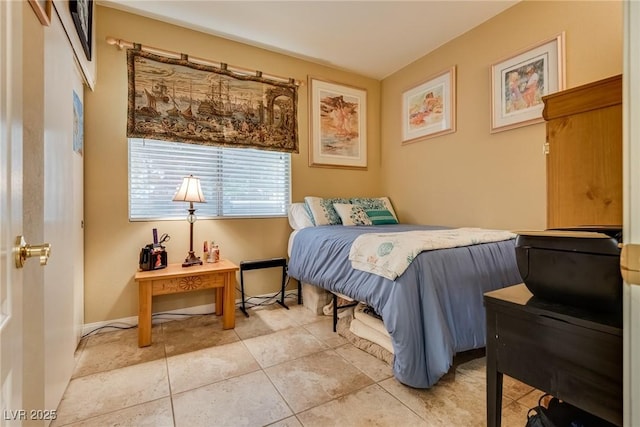 bedroom featuring baseboards and light tile patterned flooring