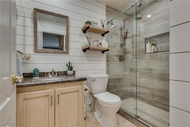 full bathroom with tile patterned floors, vanity, toilet, and a stall shower
