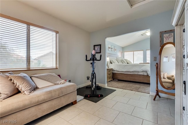bedroom featuring baseboards, light carpet, lofted ceiling, and light tile patterned flooring