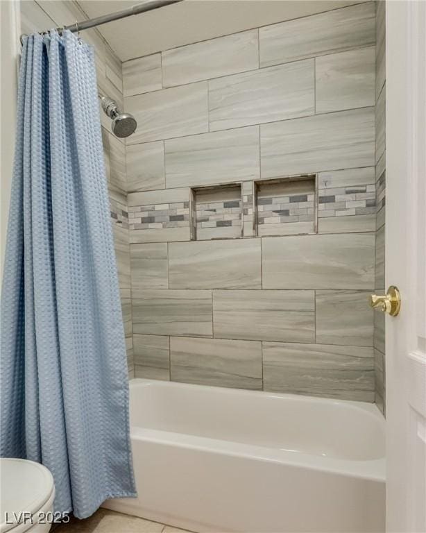 full bathroom featuring toilet, shower / bath combo with shower curtain, and tile patterned floors