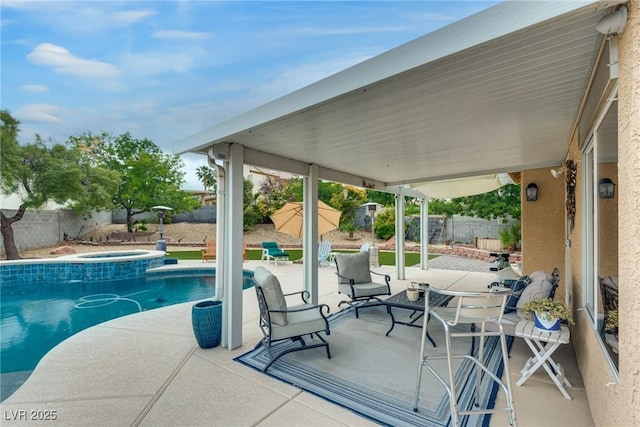 view of swimming pool featuring a fenced backyard, a patio area, and a pool with connected hot tub