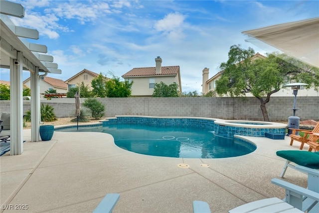 view of swimming pool featuring a fenced backyard, a patio area, and a pool with connected hot tub