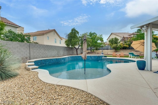 view of pool with a patio, a fenced in pool, and a fenced backyard
