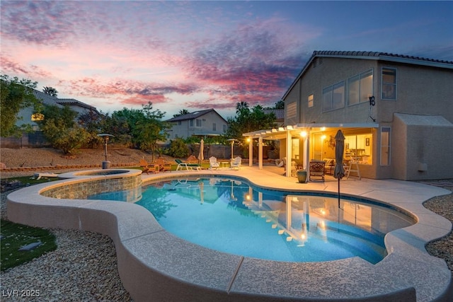 view of swimming pool featuring a patio, a pool with connected hot tub, and fence