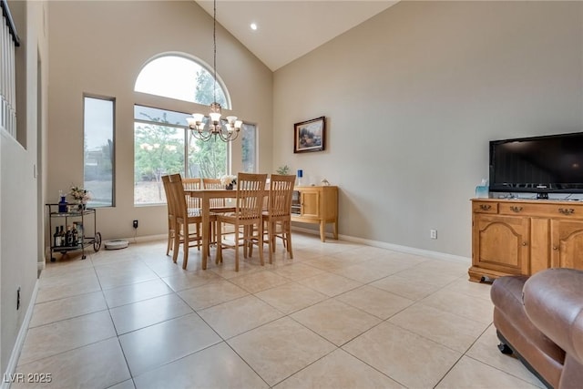 dining space with light tile patterned floors, a wealth of natural light, an inviting chandelier, and high vaulted ceiling