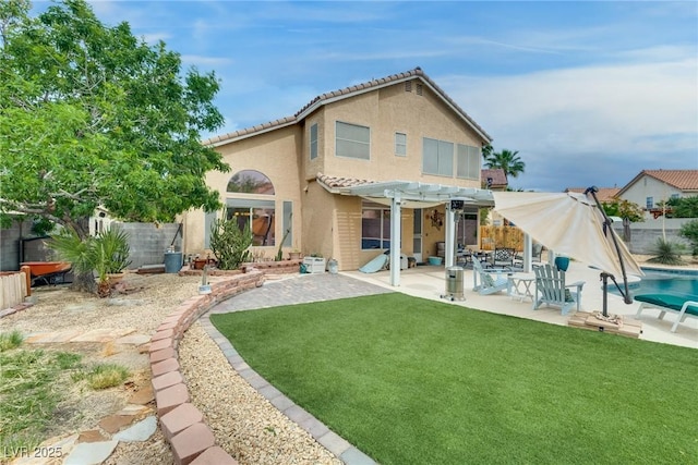 rear view of property with a yard, a patio area, stucco siding, a pergola, and a fenced backyard