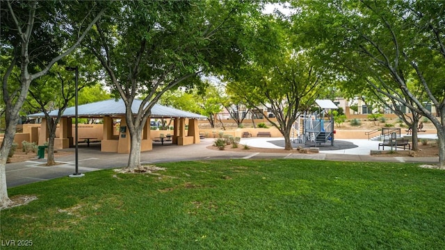 view of community featuring playground community, a yard, and a gazebo