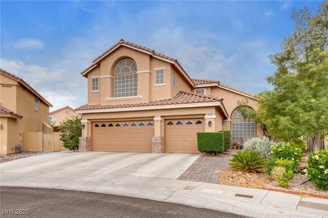 view of front of property with fence, an attached garage, driveway, stucco siding, and a tiled roof