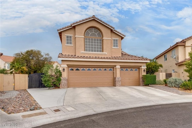view of front of property featuring driveway, stucco siding, a gate, and a garage