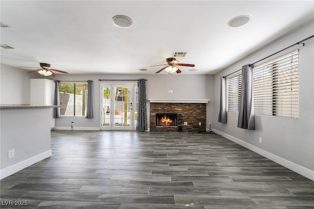 2046 Waverly Cir, Henderson, NV 89014 - unfurnished living room featuring ceiling fan, baseboards, dark wood-style floors, and a fireplace
