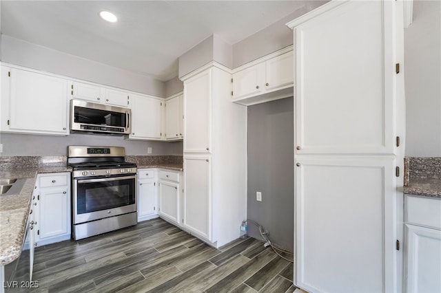 2046 Waverly Cir, Henderson, NV 89014 - kitchen featuring stainless steel appliances, dark wood finished floors, white cabinetry, light stone counters, and recessed lighting