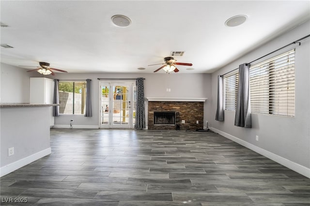2046 Waverly Cir, Henderson, NV 89014 - unfurnished living room featuring ceiling fan, baseboards, a stone fireplace, and wood finished floors