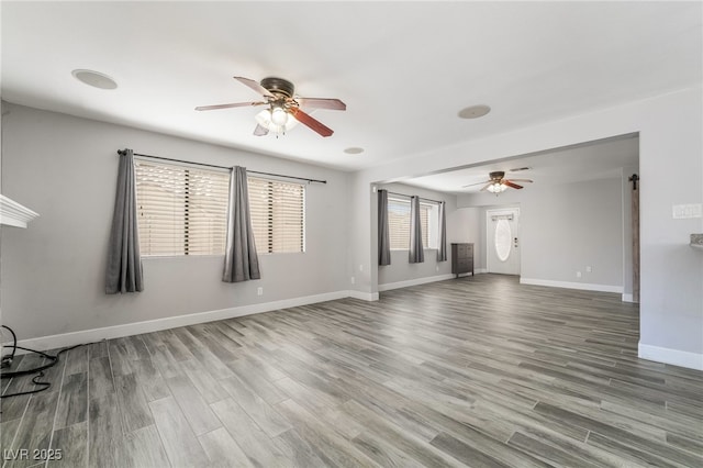 2046 Waverly Cir, Henderson, NV 89014 - unfurnished living room featuring a ceiling fan, baseboards, and wood finished floors