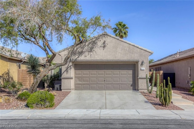 4124 Gliding Gulls Ave, North Las Vegas, NV 89084 - view of front of home with stucco siding, an attached garage, and driveway