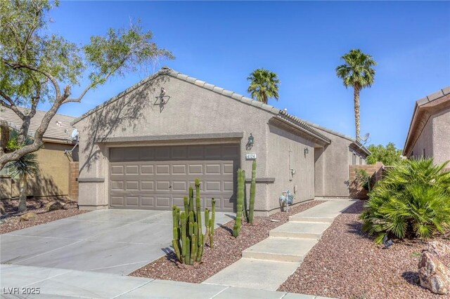 4124 Gliding Gulls Ave, North Las Vegas, NV 89084 - view of home's exterior with stucco siding, a garage, and driveway