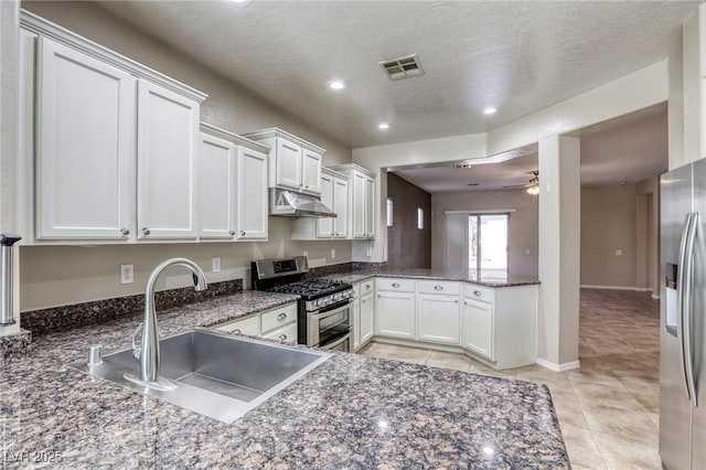 4124 Gliding Gulls Ave, North Las Vegas, NV 89084 - kitchen with appliances with stainless steel finishes, a sink, under cabinet range hood, light tile patterned floors, and a ceiling fan