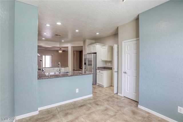 4124 Gliding Gulls Ave, North Las Vegas, NV 89084 - kitchen with stainless steel refrigerator with ice dispenser, dark stone countertops, white cabinetry, recessed lighting, and a sink