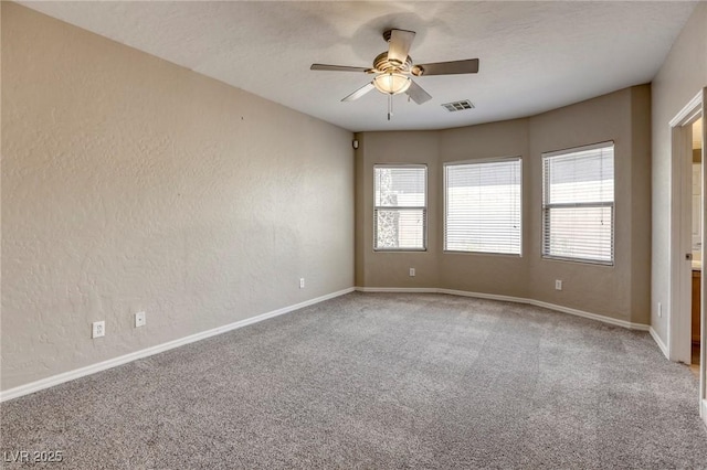 4124 Gliding Gulls Ave, North Las Vegas, NV 89084 - spare room featuring healthy amount of natural light, carpet flooring, ceiling fan, a textured wall, and baseboards