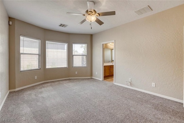 4124 Gliding Gulls Ave, North Las Vegas, NV 89084 - empty room featuring light colored carpet, a ceiling fan, healthy amount of natural light, and baseboards