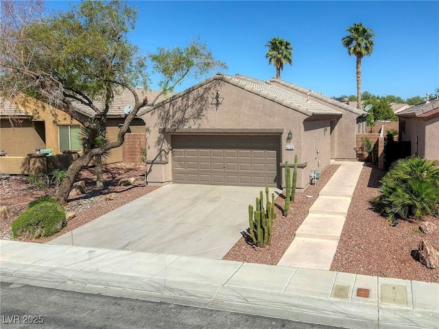 4124 Gliding Gulls Ave, North Las Vegas, NV 89084 - view of front of house featuring stucco siding, an attached garage, concrete driveway, and a tiled roof