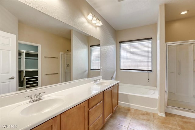 4124 Gliding Gulls Ave, North Las Vegas, NV 89084 - full bathroom featuring a stall shower, a bath, tile patterned floors, double vanity, and a spacious closet