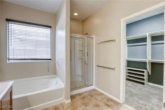 4124 Gliding Gulls Ave, North Las Vegas, NV 89084 - full bath featuring a shower stall, a bath, baseboards, and tile patterned flooring
