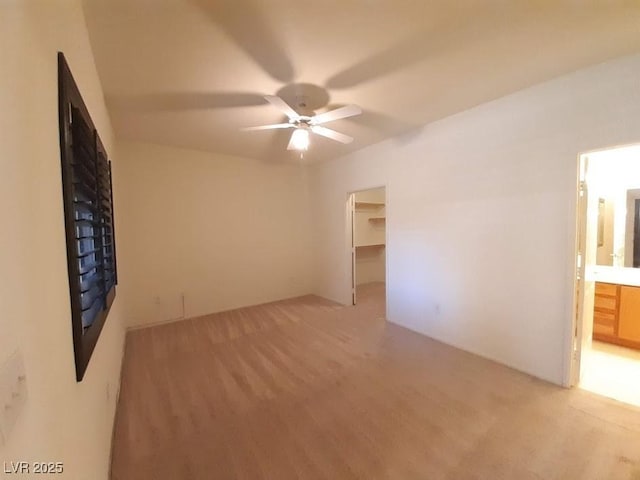 9580 W Reno Ave Unit 183, Las Vegas, NV 89148 - interior space featuring a spacious closet, a fireplace, connected bathroom, and light colored carpet
