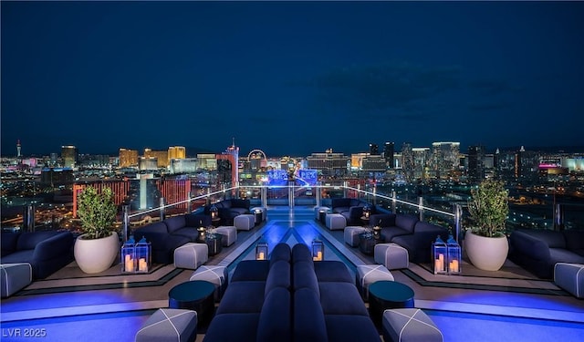 4381 W Flamingo Rd Unit 3818, Las Vegas, NV 89103 - patio at night with a balcony, outdoor dining space, a view of city lights, and outdoor lounge area