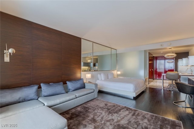 4381 W Flamingo Rd Unit 3818, Las Vegas, NV 89103 - bedroom with baseboards, a sink, and hardwood / wood-style flooring