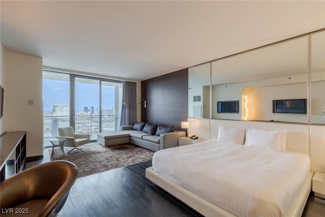 4381 W Flamingo Rd Unit 3818, Las Vegas, NV 89103 - bedroom featuring floor to ceiling windows and wood-type flooring