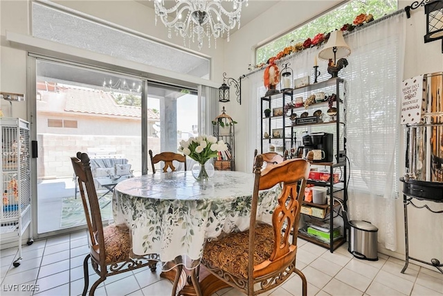 dining room featuring light tile patterned floors and a notable chandelier