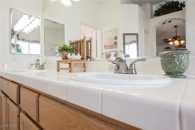 bathroom featuring a healthy amount of sunlight, double vanity, and a sink