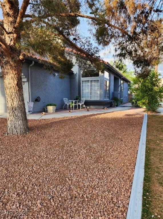 exterior space featuring stucco siding and a patio
