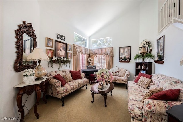 living room with carpet flooring and high vaulted ceiling