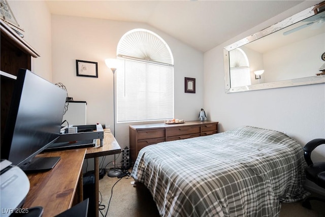 bedroom with carpet floors and vaulted ceiling