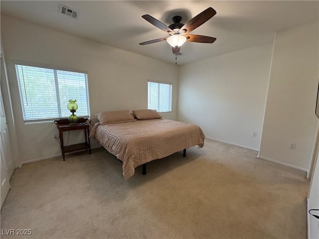 bedroom with light colored carpet, baseboards, and ceiling fan