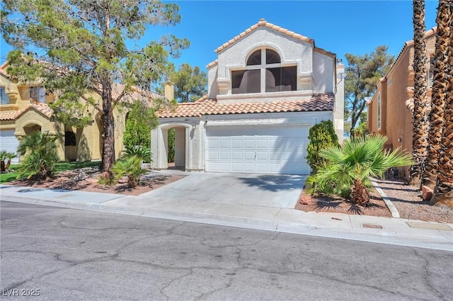 8404 Shore Breeze Dr, Las Vegas, NV 89128 - mediterranean / spanish-style home featuring a tile roof, driveway, an attached garage, and stucco siding