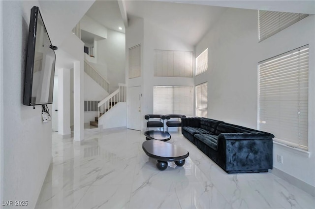 8404 Shore Breeze Dr, Las Vegas, NV 89128 - living area featuring marble tiled floors, stairs, a high ceiling, and baseboards